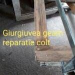 Colț de geam Giurgiuvea aflat în proces de reparație, cu un sistem de prindere vizibil.