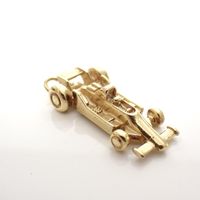 Gold pendant of a racing car