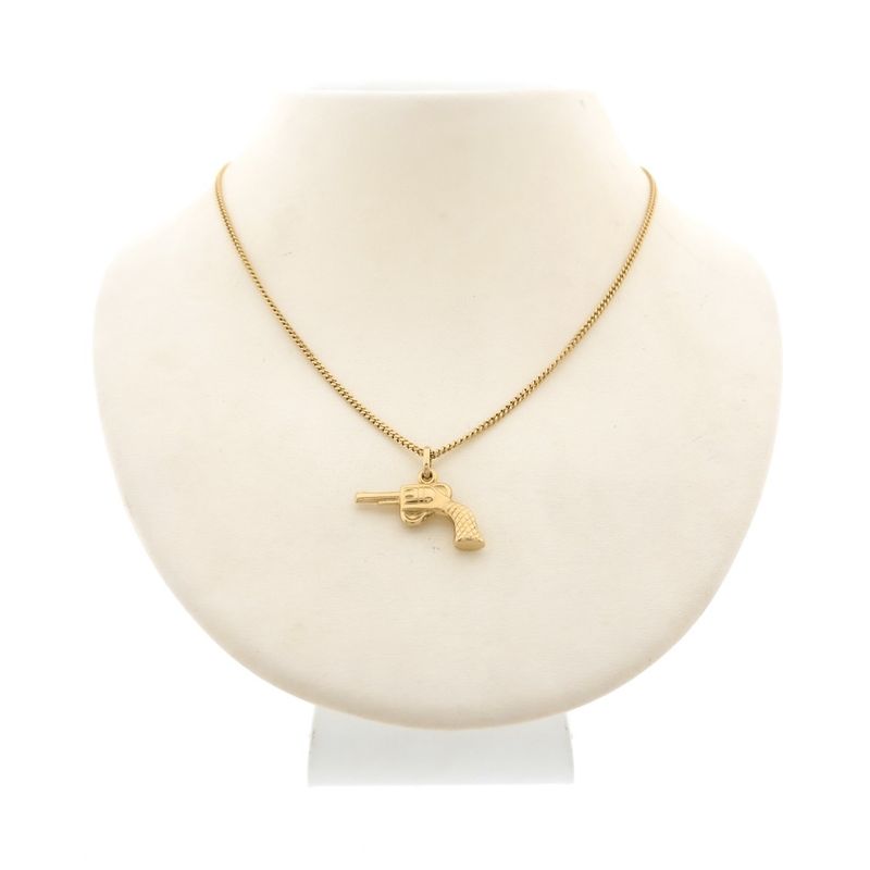 Image 3 of 18 carat gold pendant of a revolver.