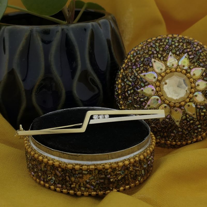 Image 2 of Two-tone gold long narrow brooch with diamonds; 0.15 ct.