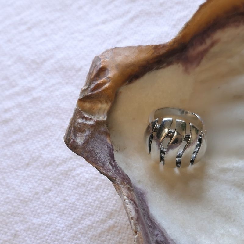 Image 2 of Silver ring with a wavy design.