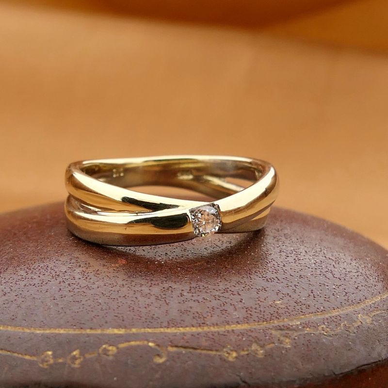 Image 2 of Gold crossover ring with diamond; 0.12 ct.