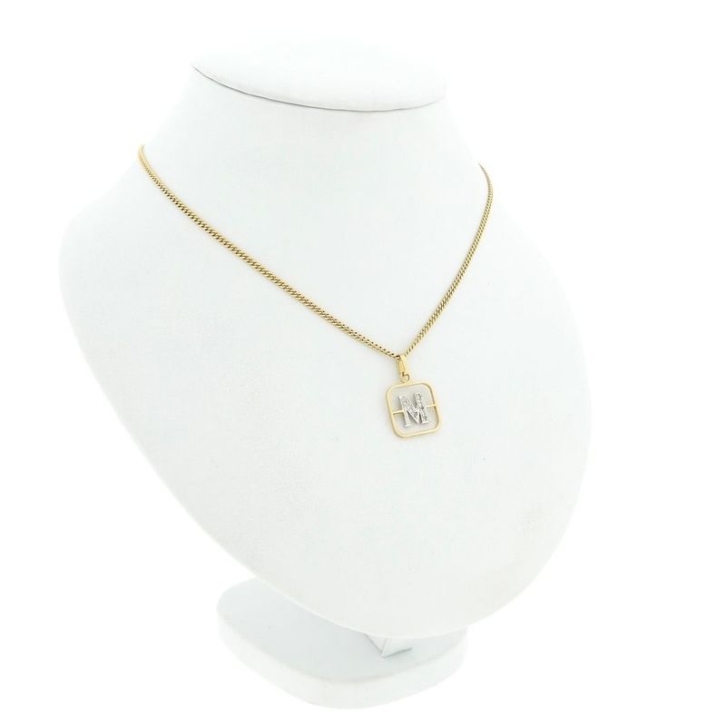 Image 4 of Two-tone gold pendant of the letter M with diamonds; 0.03 ct.