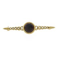 Antique gold brooch with garnet.
