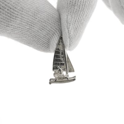 Silver charm of a catamaran Image 1 of Silver charm of a catamaran