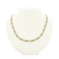 Two-tone gold necklace with a meandering pattern