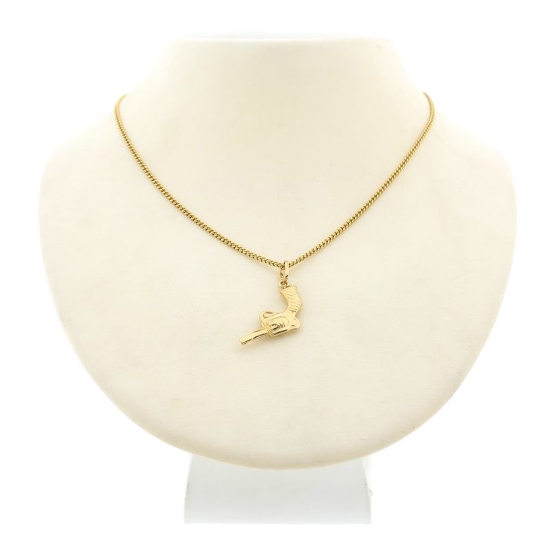 Image 4 of Gold pendant of a revolver.