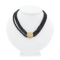 Antique garnet bead necklace with gold decorative clasp.