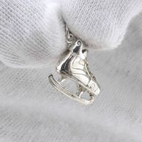 Silver pendant; Figure skate