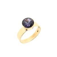 Gold ring set with a synthetic gemstone