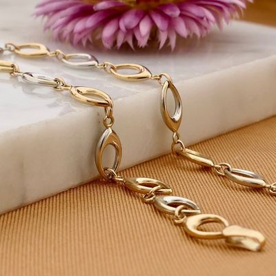 Afbeelding 2 van Bicolor gouden fantasie schakelarmband | 19 cm