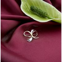 Two-tone gold brooch as a bow