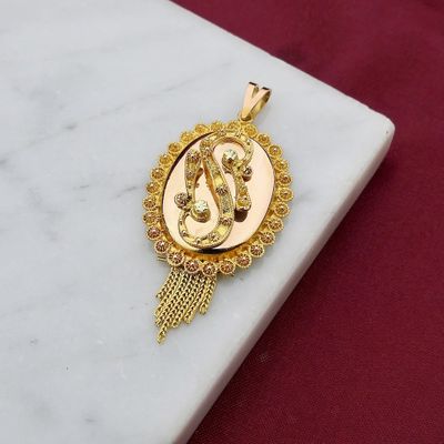 Image 2 of gold pendant of a hat bell