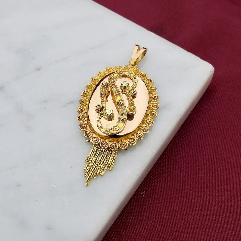 Image 2 of gold pendant of a hat bell