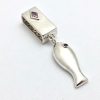 Silver pendant of a fish; amethyst