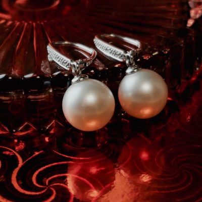 White gold stud earrings with pearl and diamond | 0.03 ct. Image 2 of White gold stud earrings with pearl and diamond | 0.03 ct.