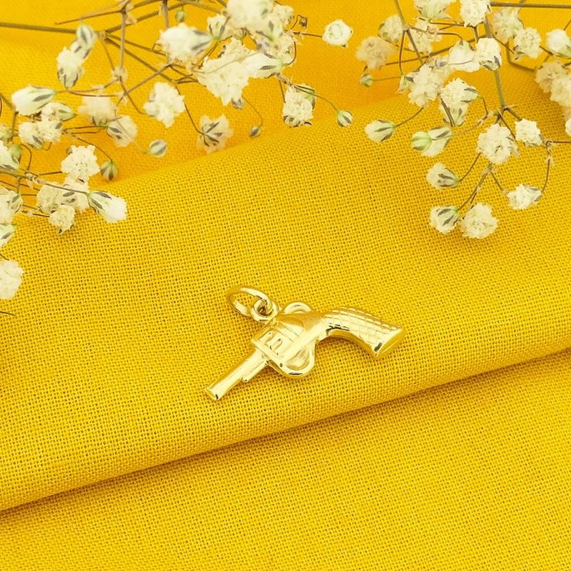 Image 2 of 18 carat gold pendant of a revolver.