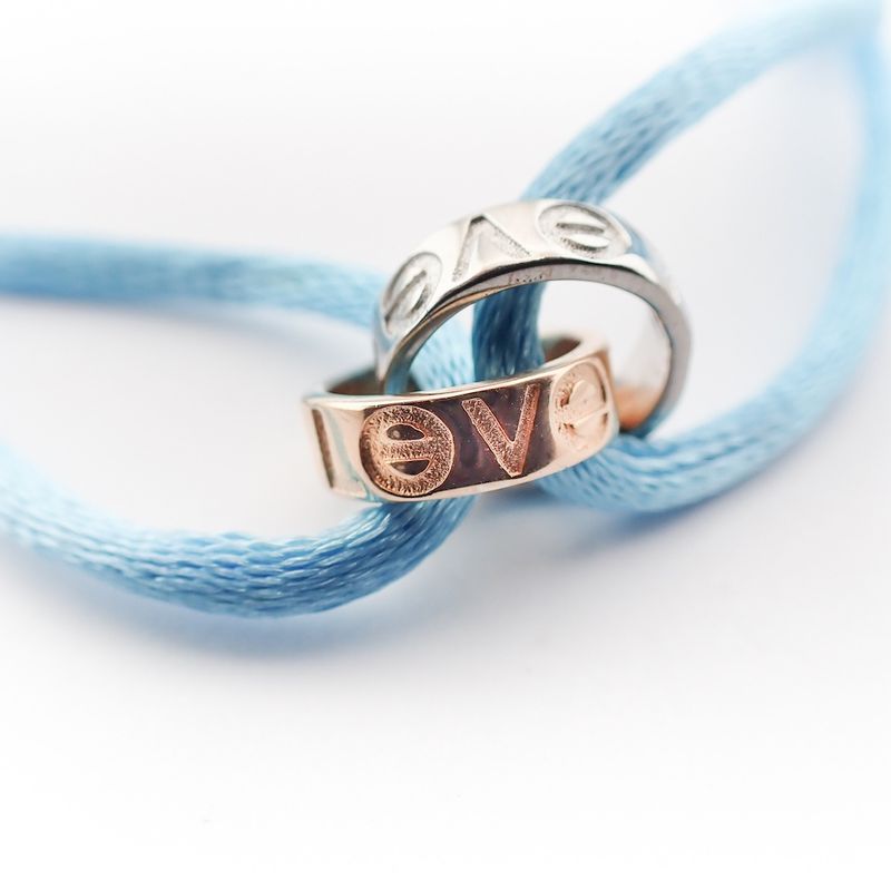 Image 3 of Bracelet made of light blue satin cord with two-tone gold rings; Løve