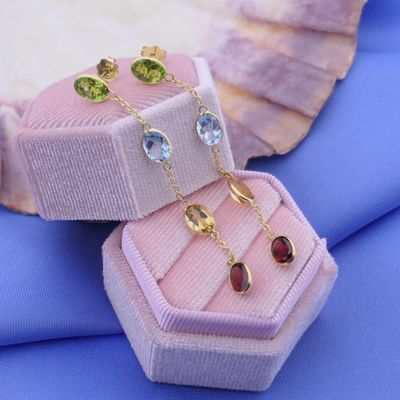 Image 2 of 18K gold stud earrings set with a mix of gemstones