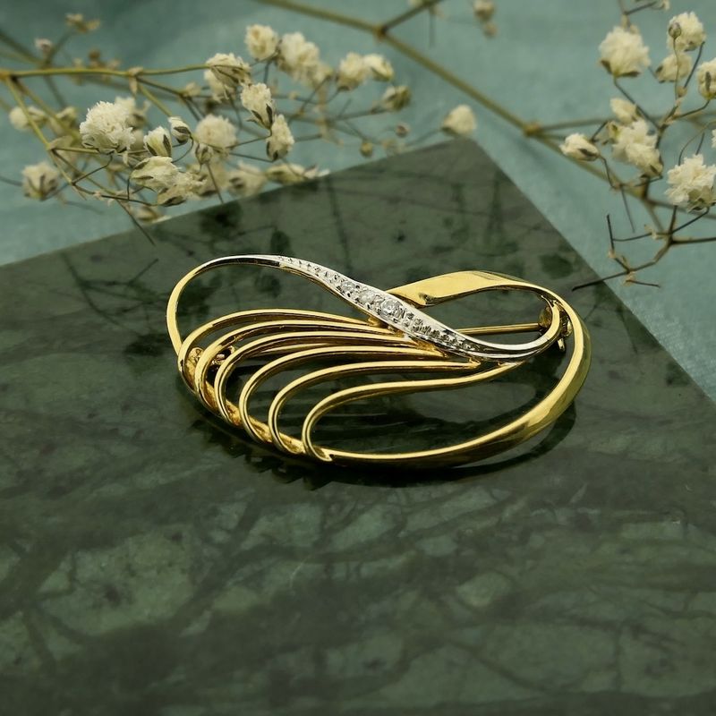 Image 2 of Two-tone gold brooch with zirconia.