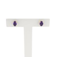 Gold stud earrings with synthetic purple gemstone