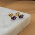 Image 2 of Gold stud earrings with synthetic purple gemstone