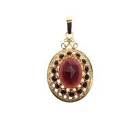 Vintage gold entourage pendant; Garnet stone