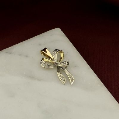 Image 2 of Two-tone gold bow pendant with diamond | 0.04 ct.