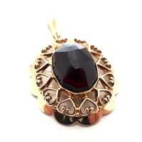 Vintage gold pendant with garnet stone.