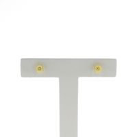 Gold stud earrings with diamond-cut button