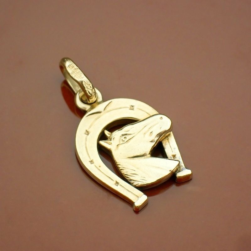 Image 2 of Gold pendant of a horse with a horseshoe