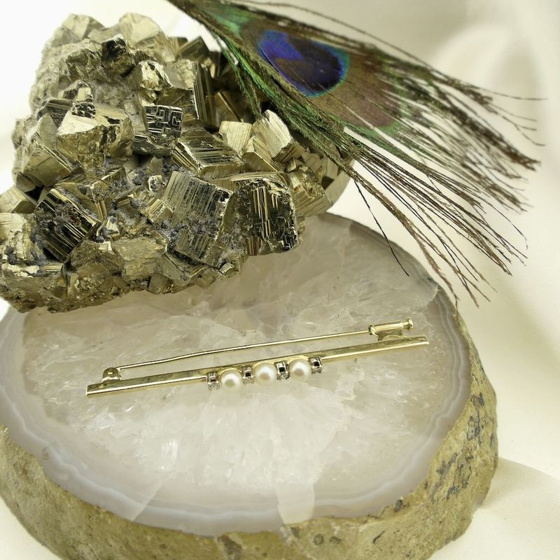 Image 2 of Golden long narrow brooch with pearl and diamonds; 0.10 ct.