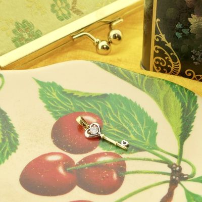 Image 2 of Two-tone gold pendant of a key with zirconia