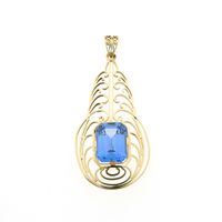 Gold pendant with light blue tourmaline.