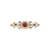 Gold brooch with blood coral