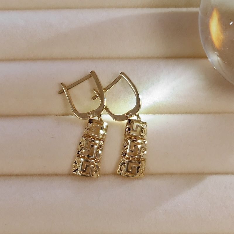 Image 2 of Gold earrings with meander pendant.