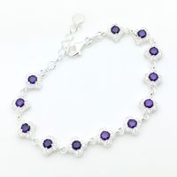 Silver bracelet set with white and purple zirconia