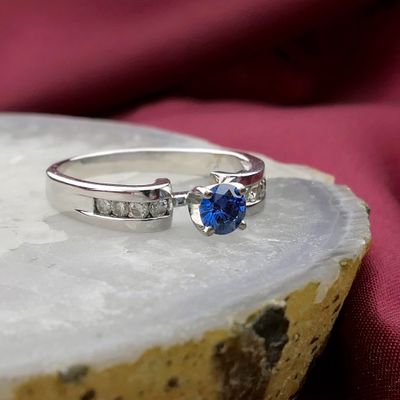 Image 2 of White gold solitaire ring with white and blue diamonds; 0.74 ct.