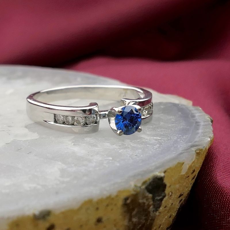 Image 2 of White gold solitaire ring with white and blue diamonds; 0.74 ct.
