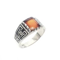 Silver ring with orange zirconia and Maori pattern