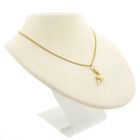 Image 6 of Gold pendant of a revolver.