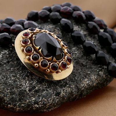 Antique garnet bead necklace with gold decorative clasp. Image 2 of Antique garnet bead necklace with gold decorative clasp.