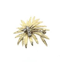 Vintage gold brooch with zirconia.