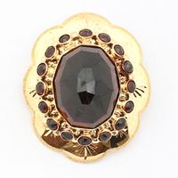 Antique gold brooch with garnet