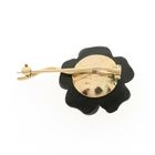 Image 6 of Gold flower brooch with onyx and diamond | 0.60 ct.