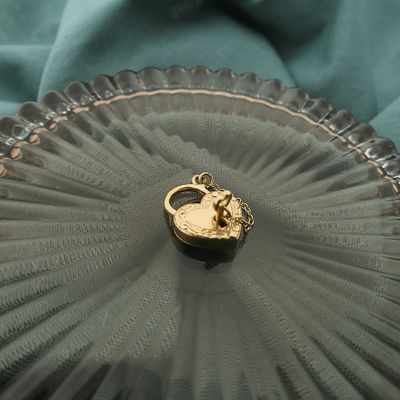 Image 2 of Gold pendant of a heart with a key