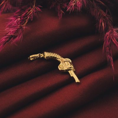 Image 2 of Gold pendant of a revolver.