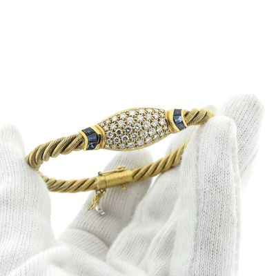 Image 1 of 18-karat gold twisted bracelet with sapphire and diamond; 1.11 ct. | Wellendorff