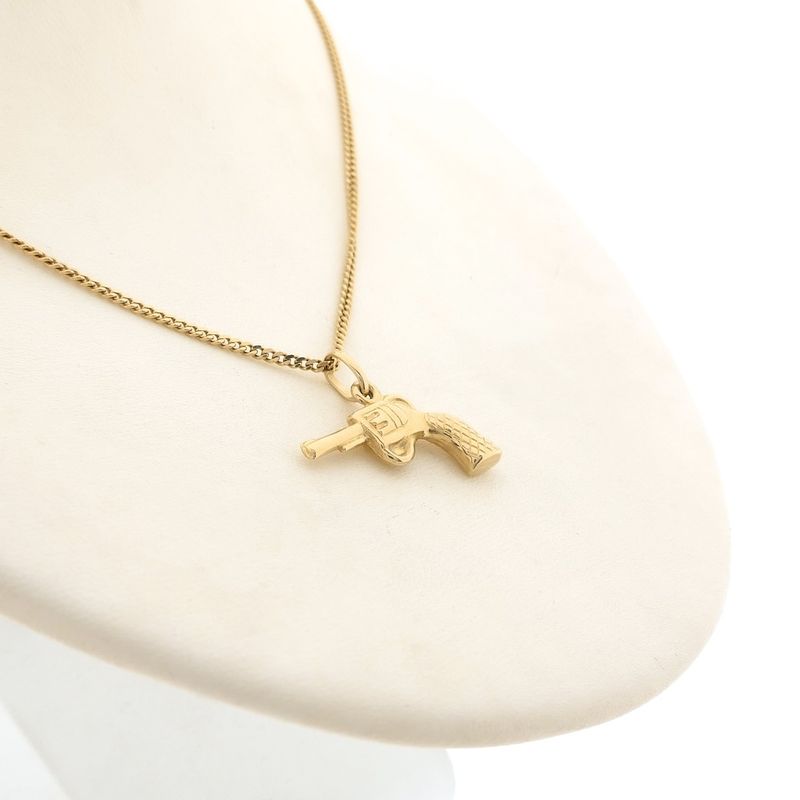 Image 5 of 18 carat gold pendant of a revolver.
