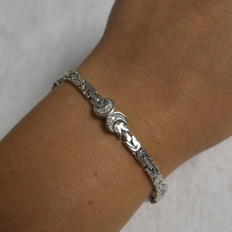 Image 12 of White gold flat king bracelet with fixed charms and 0.24 ct diamond.